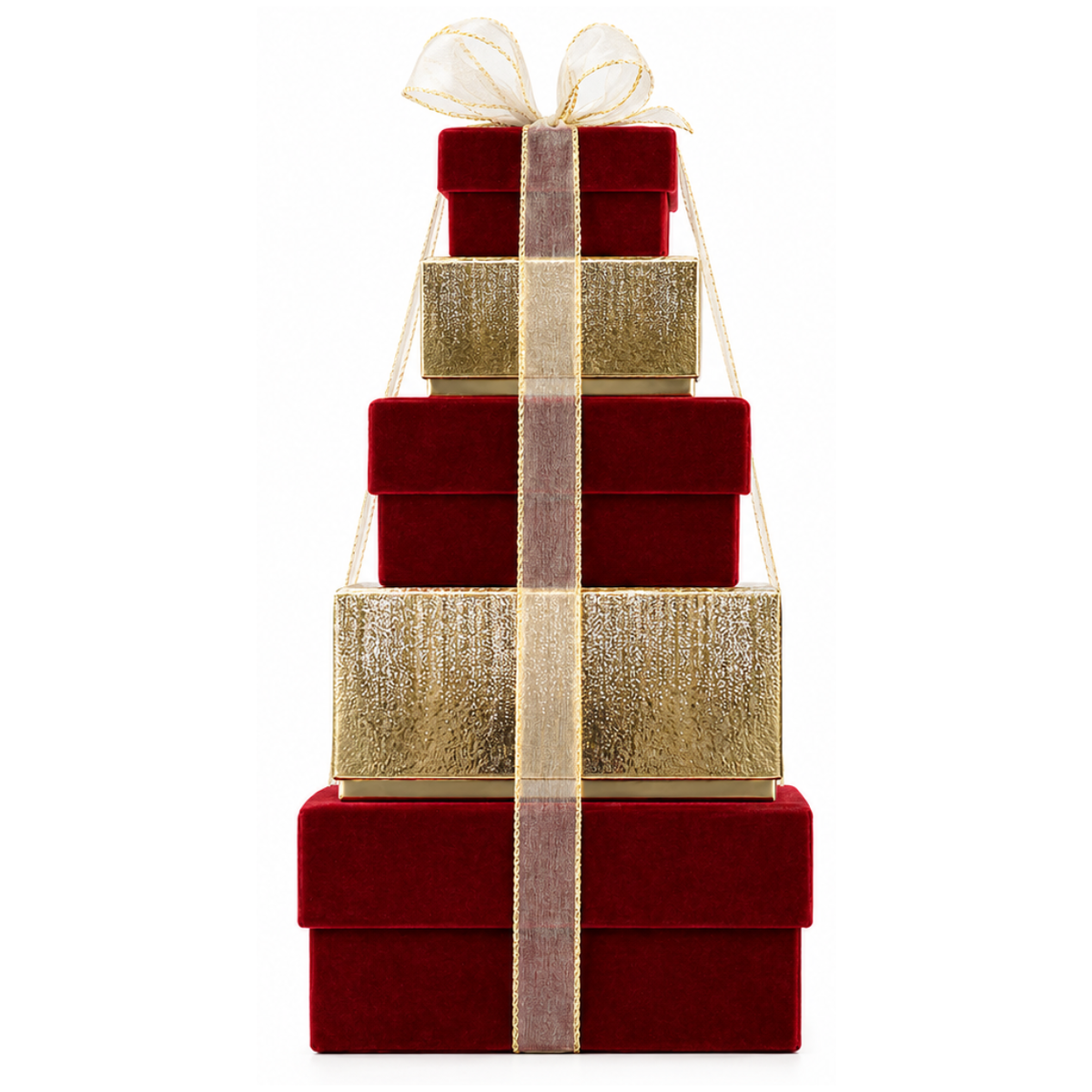A stack of four tiered gift boxes in deep red velvet and metallic gold, tied together with a sheer gold ribbon and bow, on a solid white background.