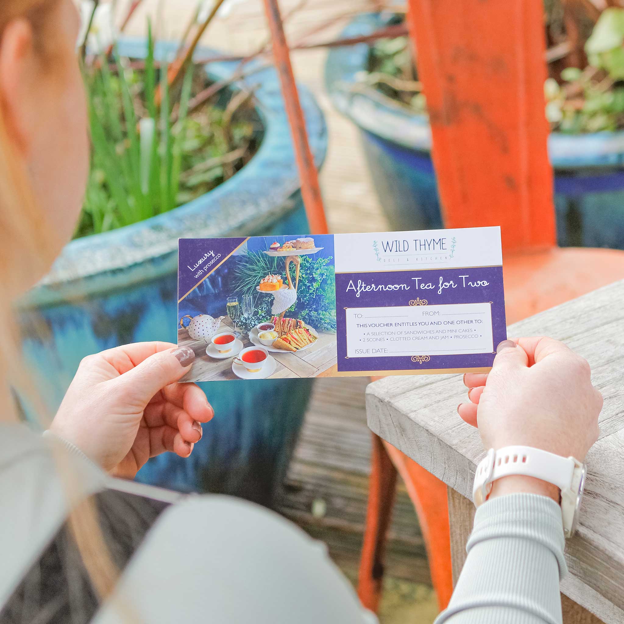 Lady looking at an Afternoon Tea for Two Voucher from China Blue