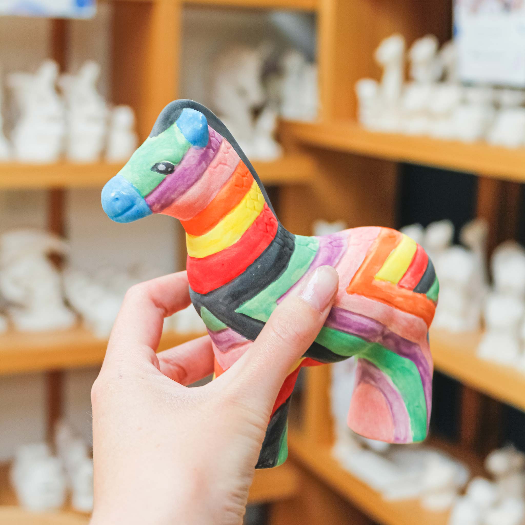 Rainbow painted ceramic zebra